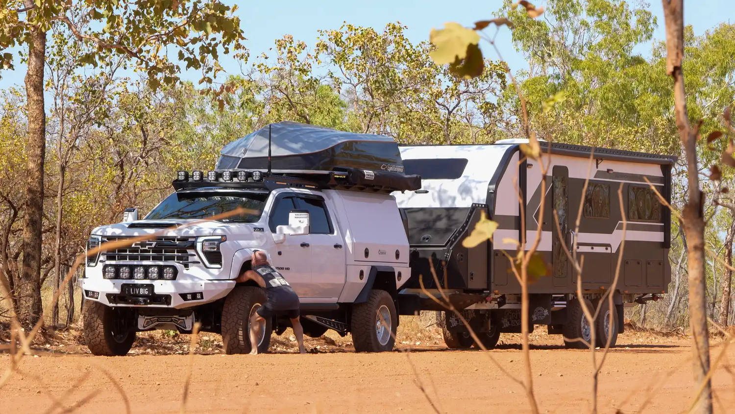 Their Silverado and Offroad Grit RV parked on red dirt