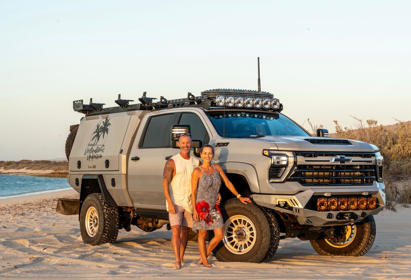 Miriam and Chris from Aussie Destinations Unknown with their Silverado on the beach