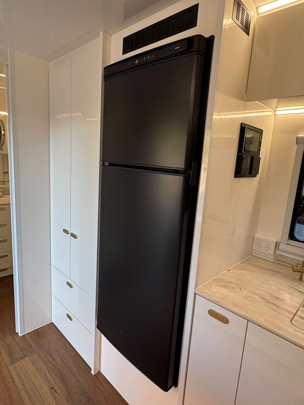 The 274 L compressor fridge built in beside a full-height pantry