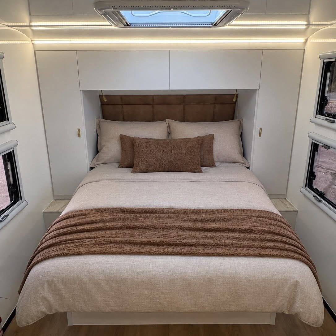 Bedroom with leather bedhead and overhead cupboards