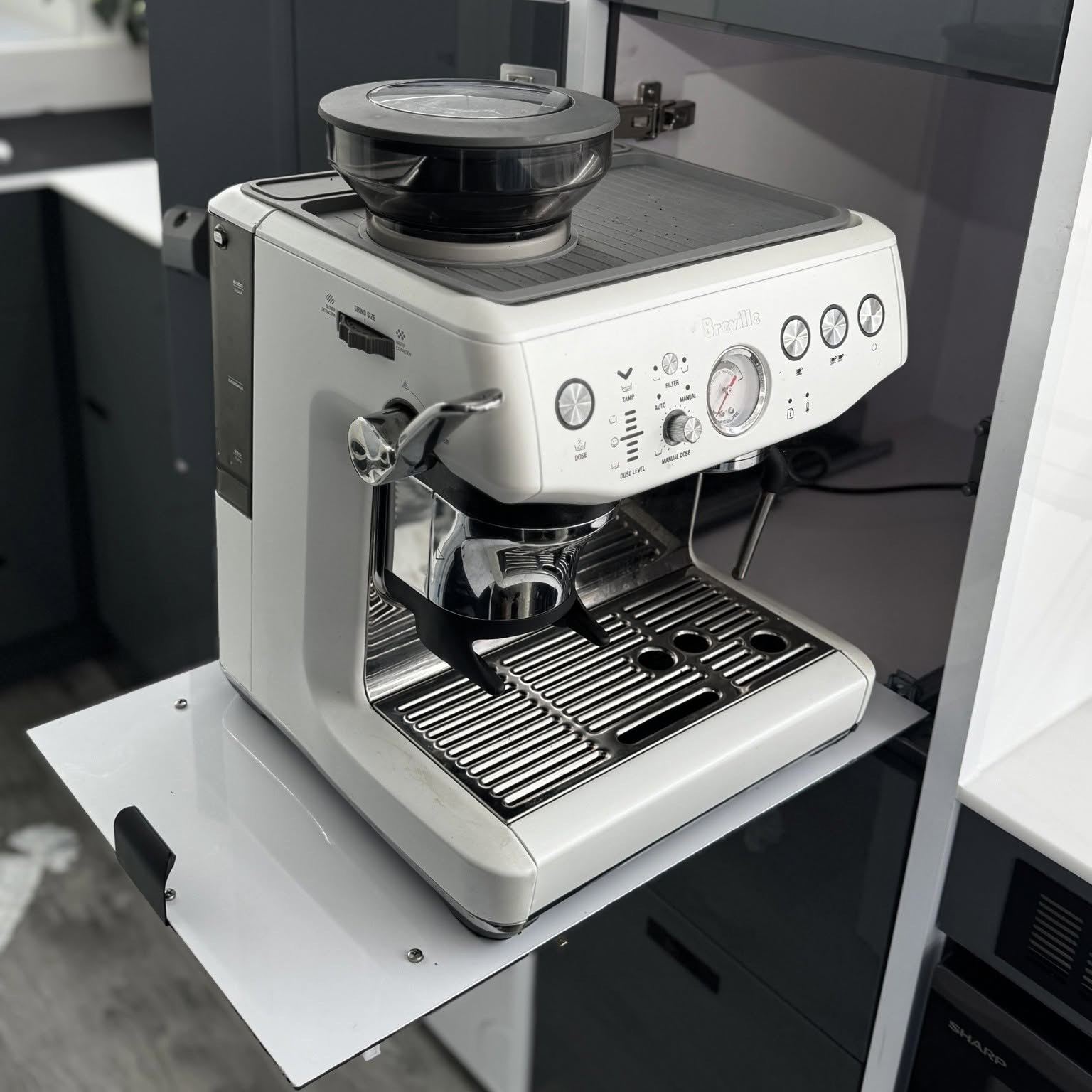 Coffee machine on its own slide-out shelf