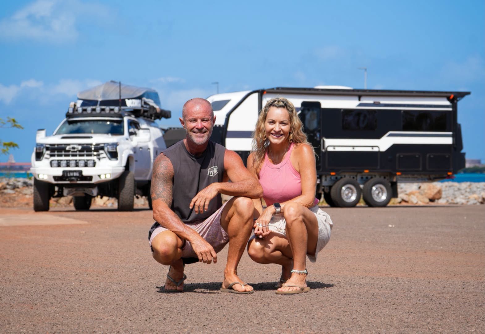 Chris and Miriam with their van and ute by the water