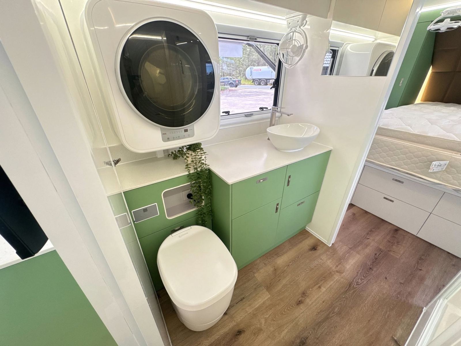 Ensuite with washing machine and green vanity