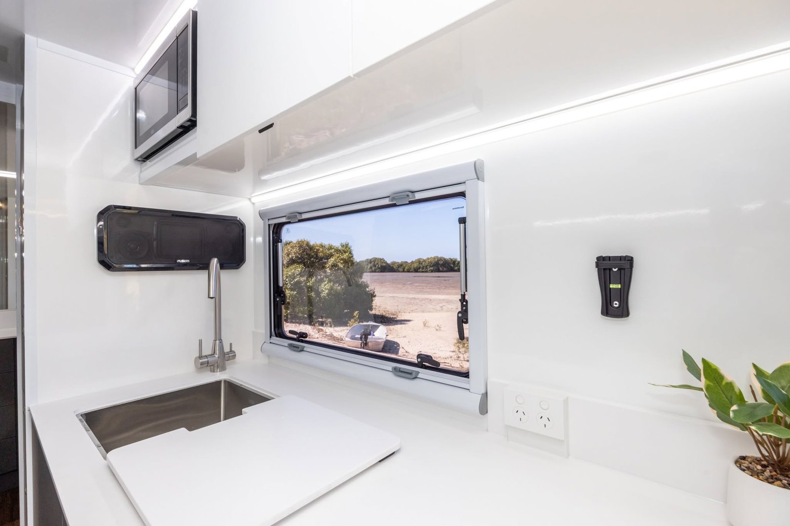 Standard brushed nickel 3-way mixer over a stainless sink, with the microwave above