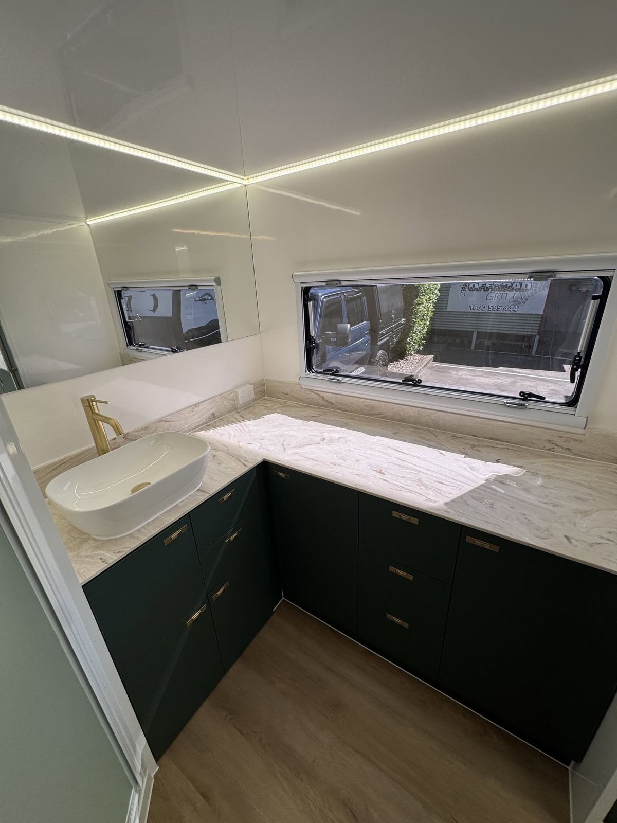 Dark green vanity with gold tap