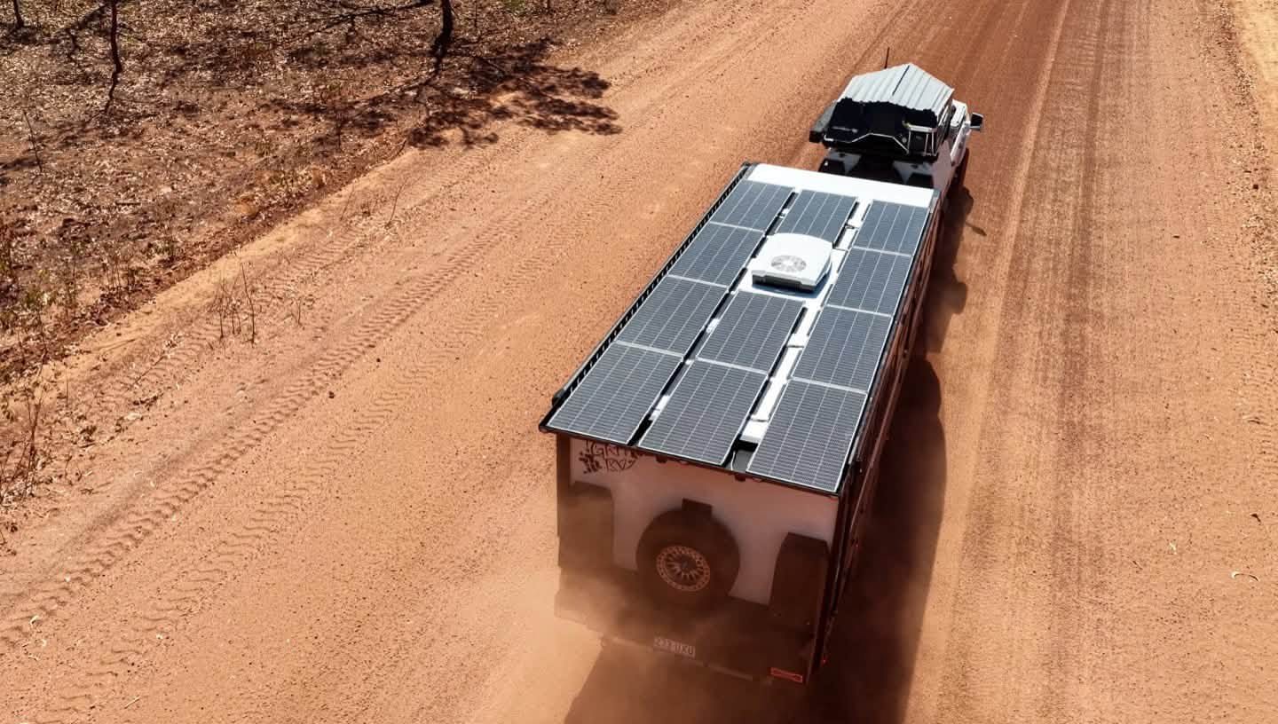 Solar across the whole roof, from above on a red dirt road