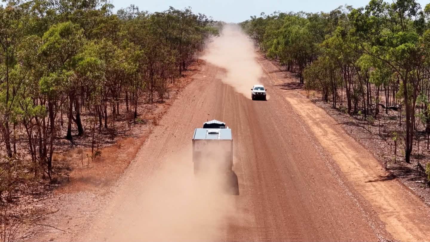 Dust behind on a long red road