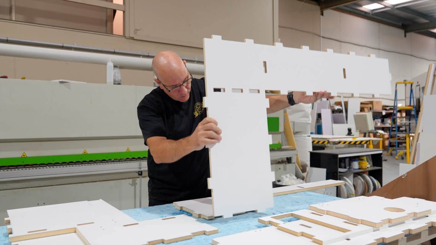 Putting together CNC-cut cabinetry in our factory