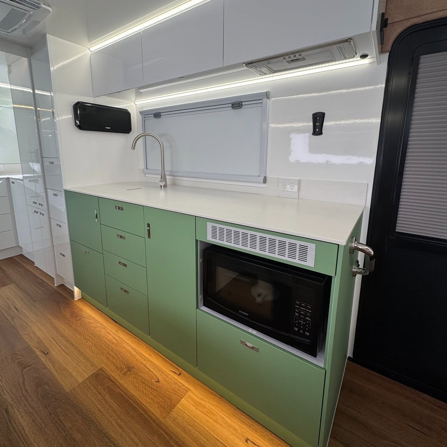 Green kitchen with tile splashback