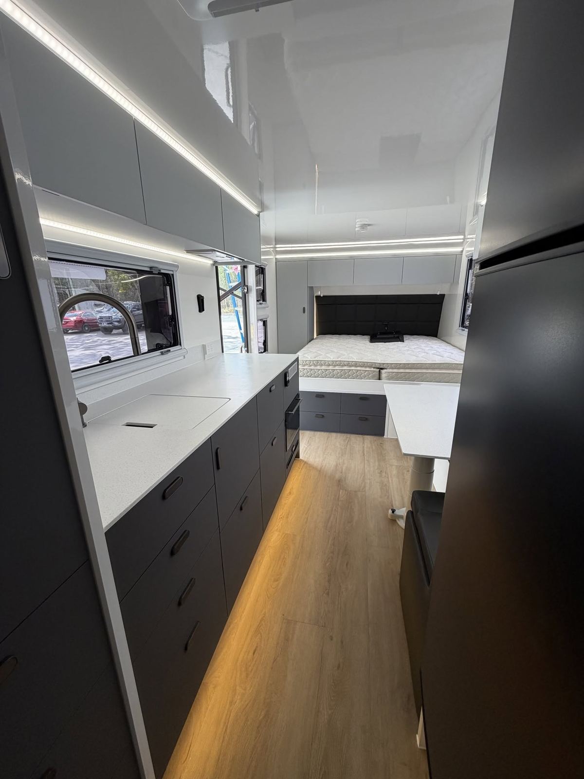 Black and white kitchen through to the bed