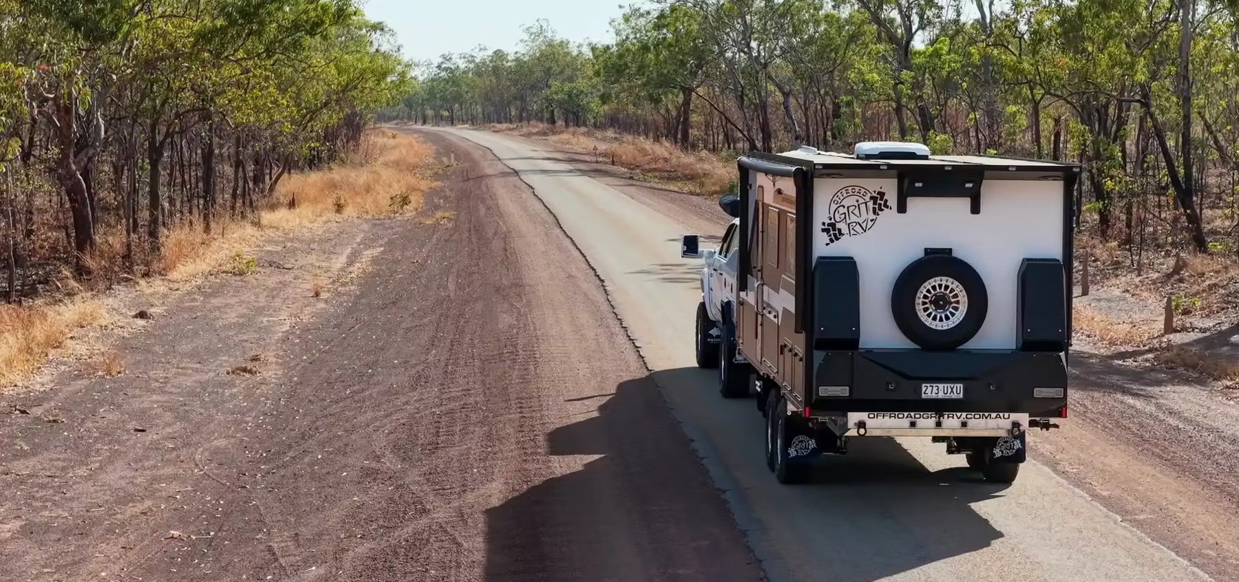 An Offroad Grit RV from behind on a bush road, from the air