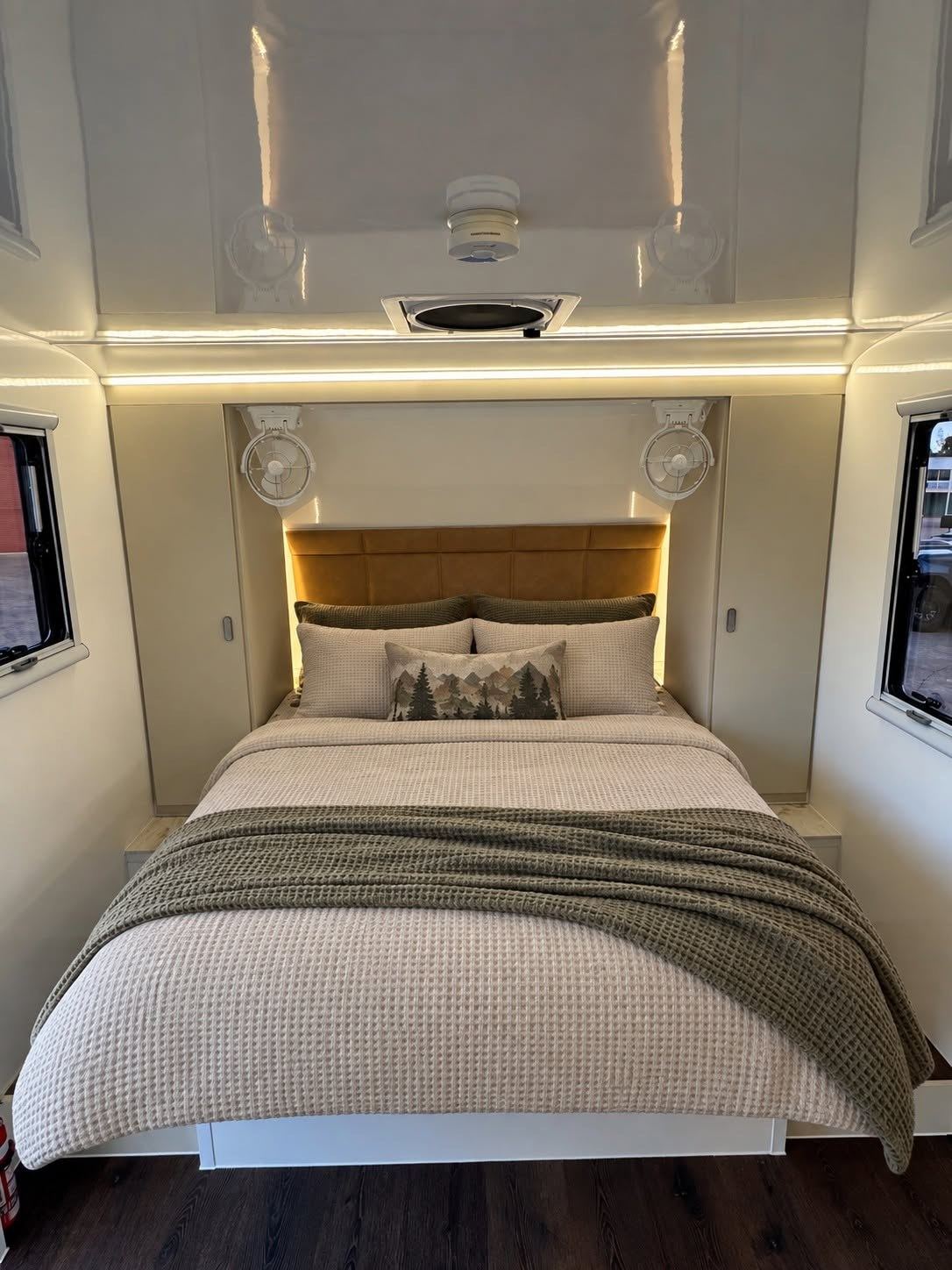 Bedroom with padded bedhead and throw