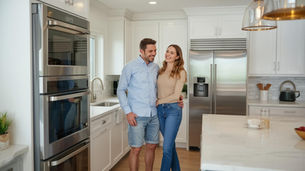 Couple in kitchen with new appliances