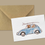 Thumbnail: Fox and welsh terrier dog in a vintage beetle car with surfboard greeting card