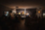 A wide shot captures the dynamic performance, with the stage alive and the audience captivated.