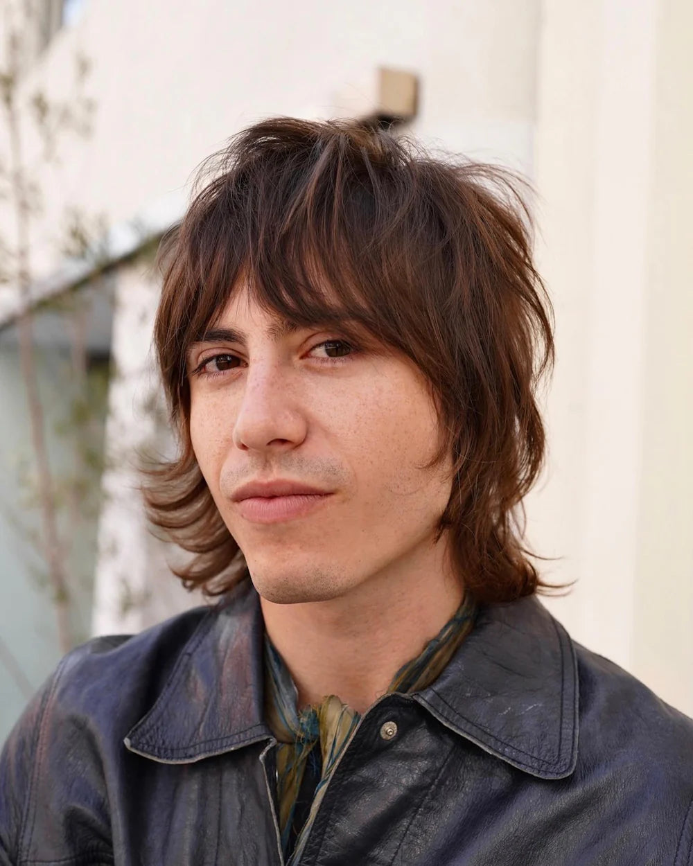 Man posing with an 80’s style hair cut