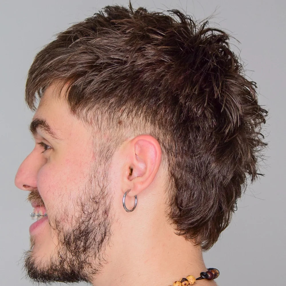 A side shot of a male model posing looking to the left, smiling