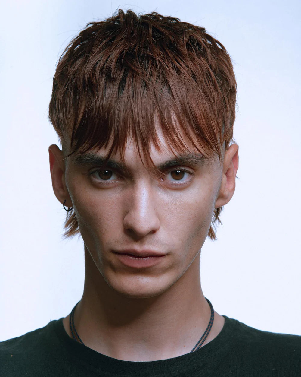 Model posing with short mullet with an undercut