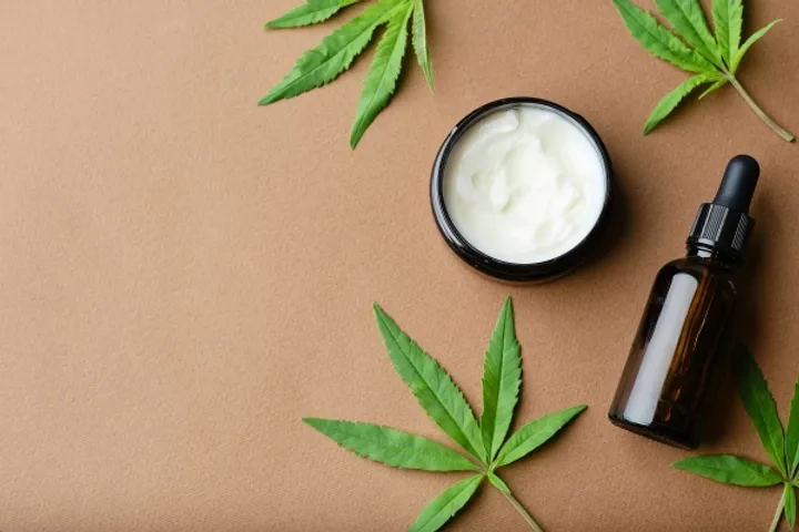 top-view-cannabis-cosmetic-oil-cream-jar-bottle-green-plant-leaf-natural-cosmetic-brown-background-flat-lay-copy-spacexa