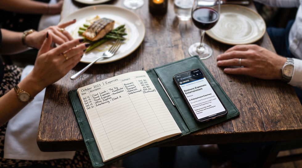 An overhead view of a UK business expenditure ledger and a smartphone displaying HMRC entertainment rules at a restaurant table.