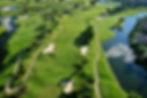 Aerial view of a luxury championship golf course featuring pristine fairways, palm trees, water hazards, and resort-style landscapes, ideal for international golf travel experiences and tournaments.