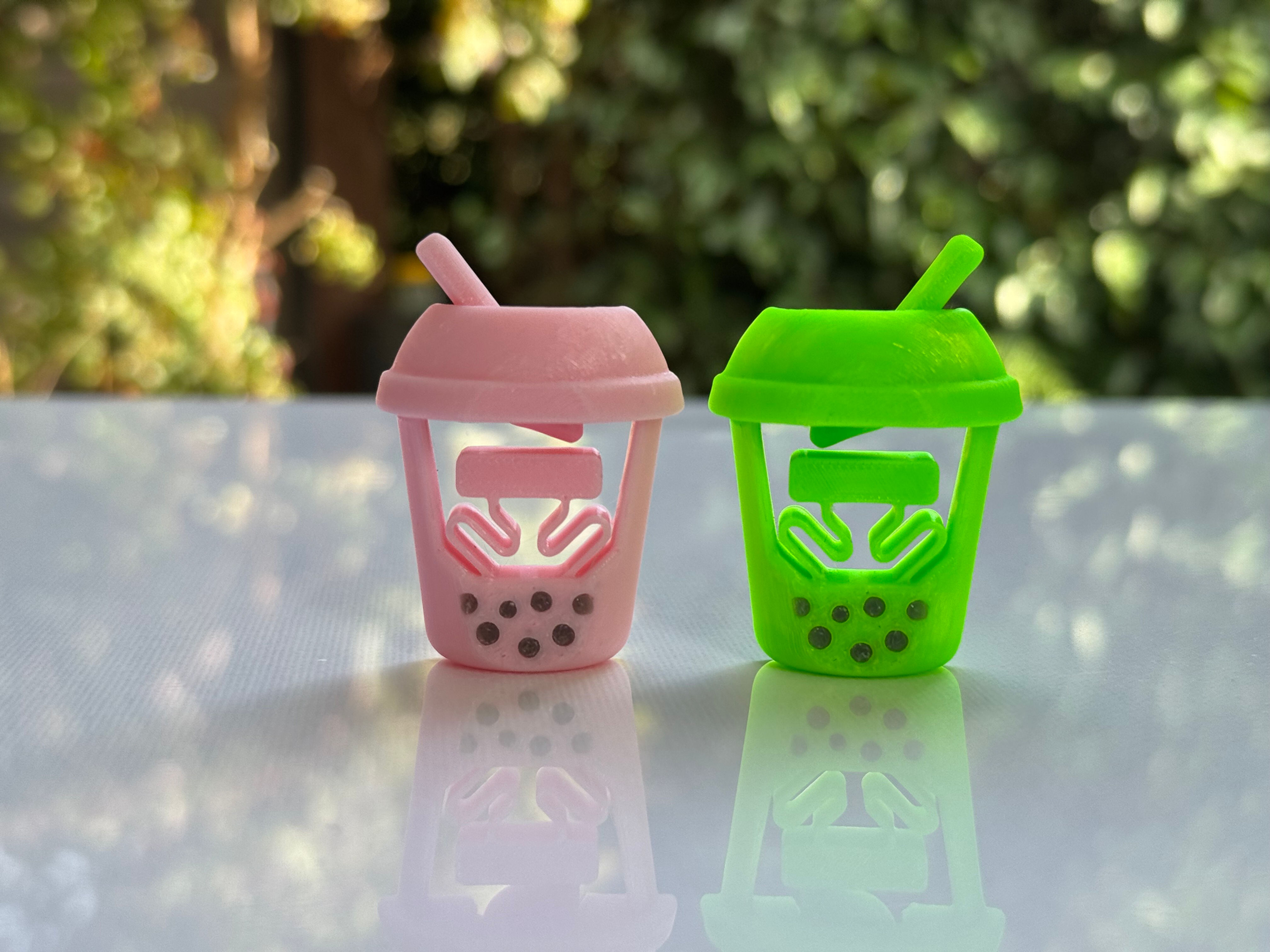 Pink and green boba tea clickers