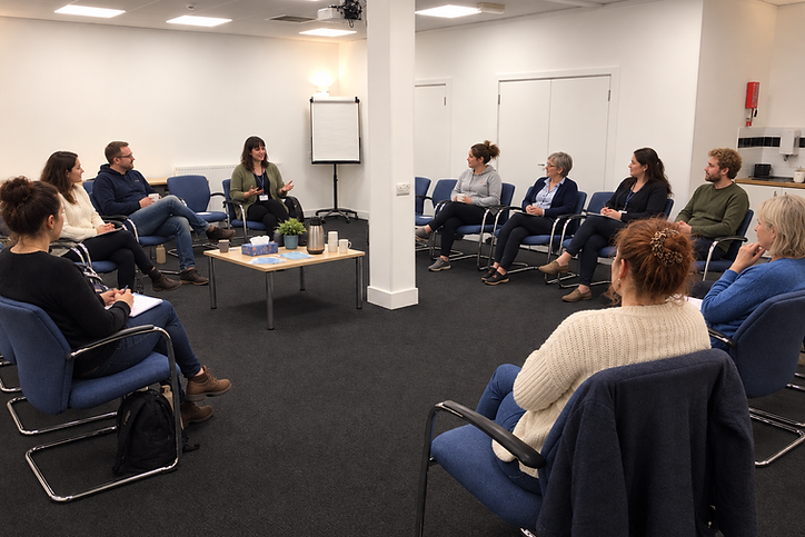Community group meeting in a circle at Faraday House, Eastbourne
