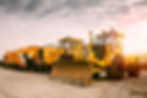 two-heavy-wheeled-tractor-one-excavator-other-construction-machinery-morning-sun.jpg