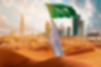A man holding Saudi flag