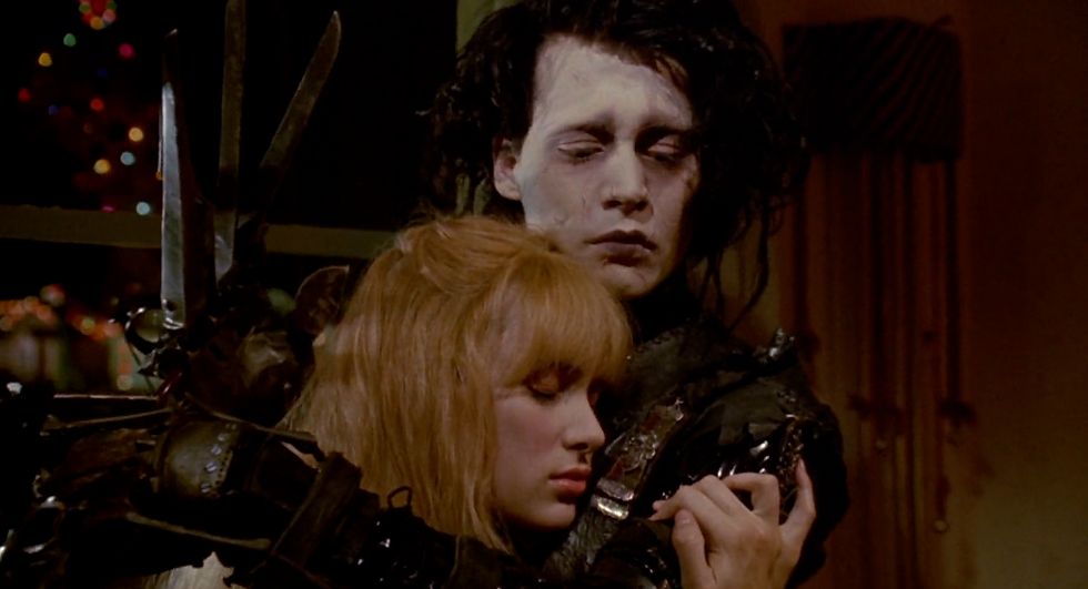 A frame from Tim Burton's iconic film, Edward Scissorhands, depicting Edward trying to hold Kim without hurting her.