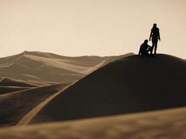Two people in the desert of Arrakis.