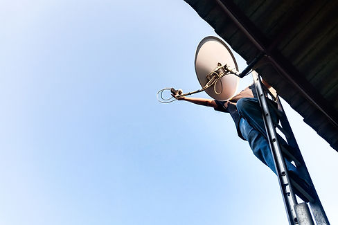 Technicians are installing and debugging satellite dish systems installed on their homes w