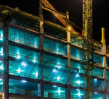 Construction at night with lights against the dark sky.jpg