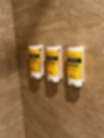 Three bottles of soap, shampoo, and condition attached to the shower