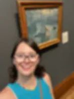 Annie taking a selfie in front of a boat painting