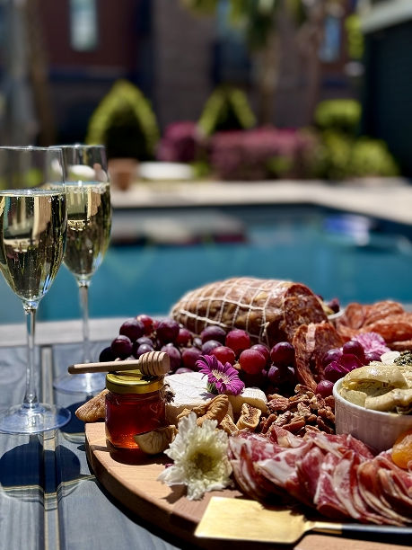 The Social Setting's backyard pool party soiree charcuterie and champagne drop in Charleston