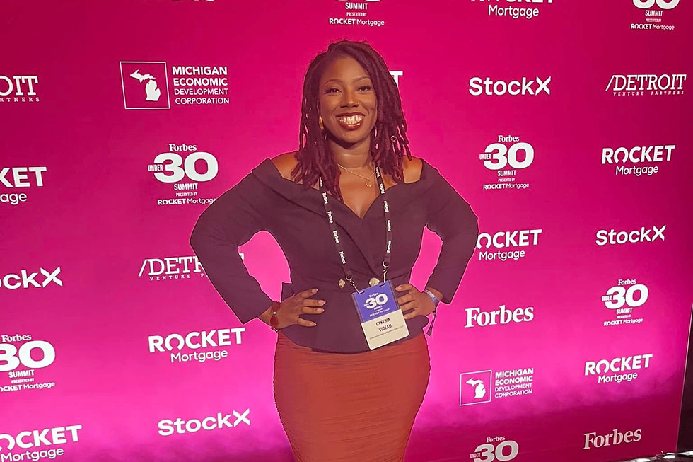 Dr. Cynthia Videau in black blazer and red skirt at the Forbes 30 Under 30 Summit in Detroit, Michigan