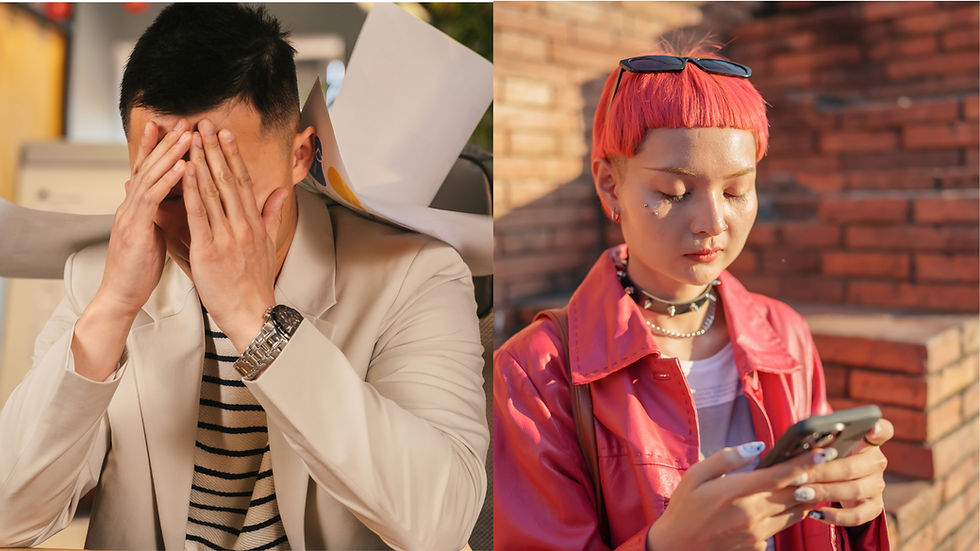 Two individuals side by side: one covers face in frustration, wearing a blazer; the other checks phone, wearing a pink jacket, against brick wall.