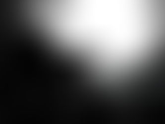 Silhouetted man sits curled up in a concrete tunnel, facing bright light; iStock Credit: baona and 2149642583 visible.