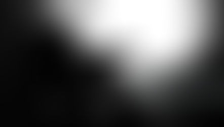 Silhouetted man sits curled up in a concrete tunnel, facing bright light; iStock Credit: baona and 2149642583 visible.