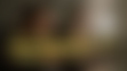 Man sitting with his head in hands while woman looks on in the background, both appearing emotionally distant—depicting the emotional disconnect, loneliness, and trust issues explored in the blog “Why Don’t Relationships Last Anymore?” on Lovely Tiny Things.