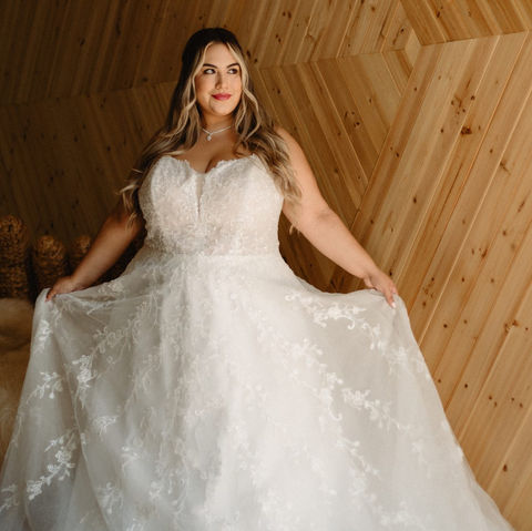 Stella York Plus Size Wedding Dress, Bride Standing in Front of Wooden Wall