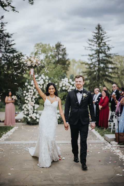 Couple walking down the aisle and bride is cheering