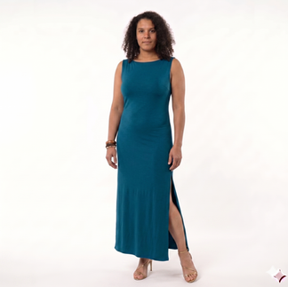 A curly-haired model wearing a sleeveless Moroccan blue Laura maxi dress with a boatneck cowl neckline