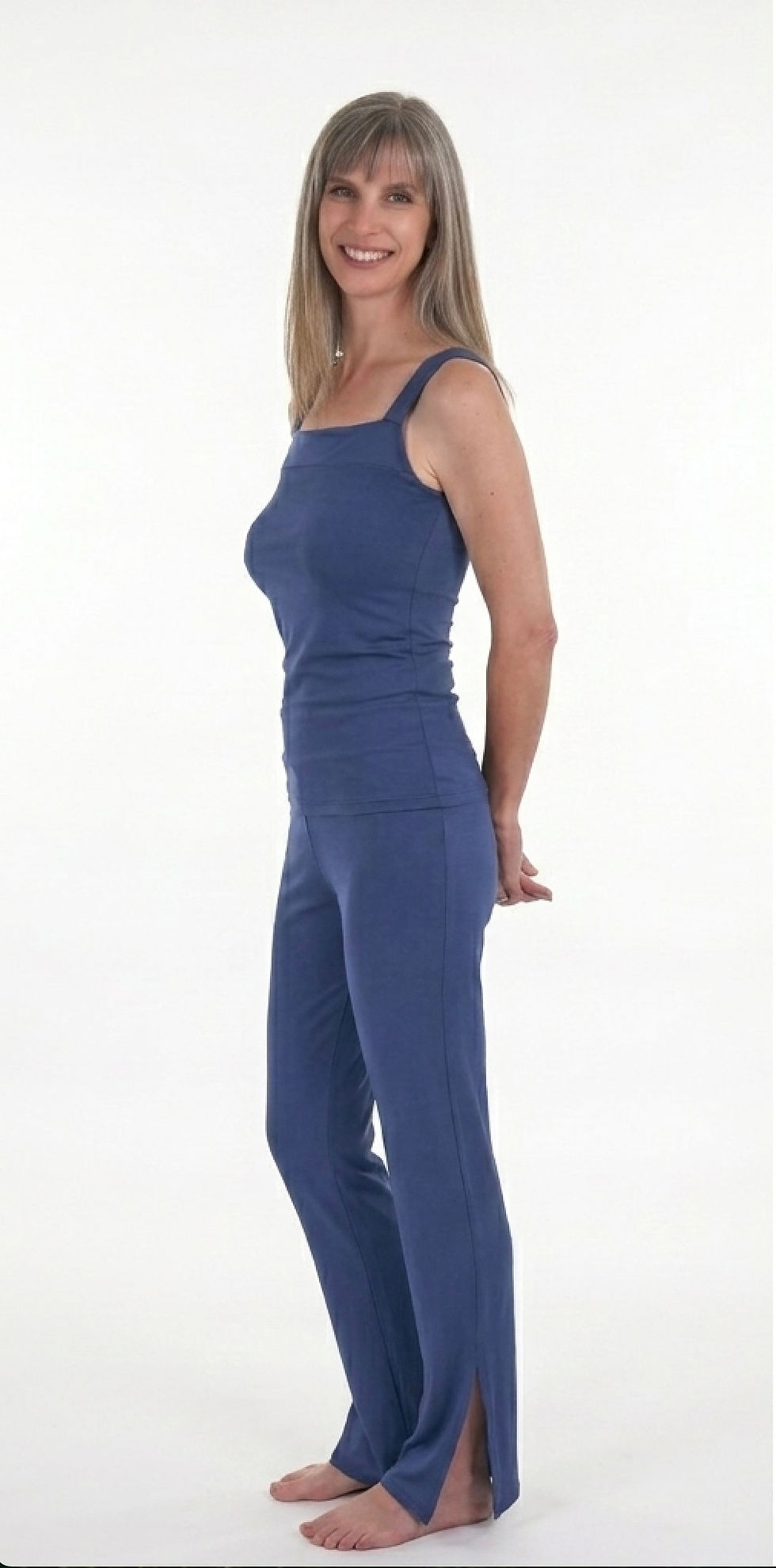 Grey haired model wears a bamboo leisure set in Twilight Blue, the square neck bamboo top paired with the bamboo Straight leg pants by designer Muse By Laura