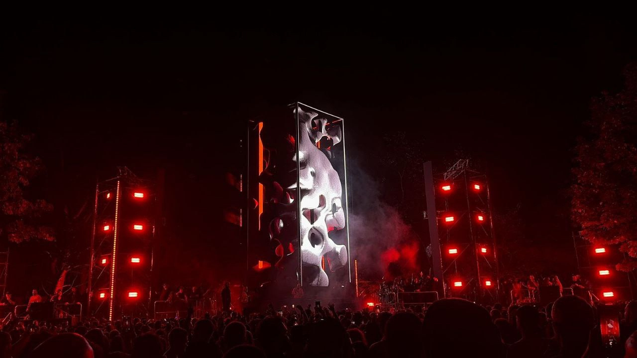 Boris Brejcha stage with vertical LED imagery and red lighting.
