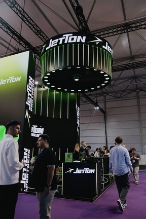 Jetton Games stand with an illuminated overhead turbine.