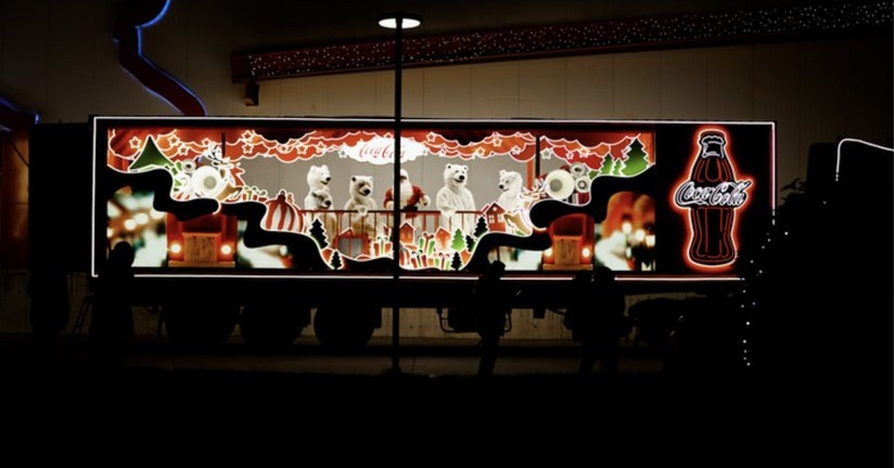 Illuminated Coca-Cola Christmas truck and trailer stage.