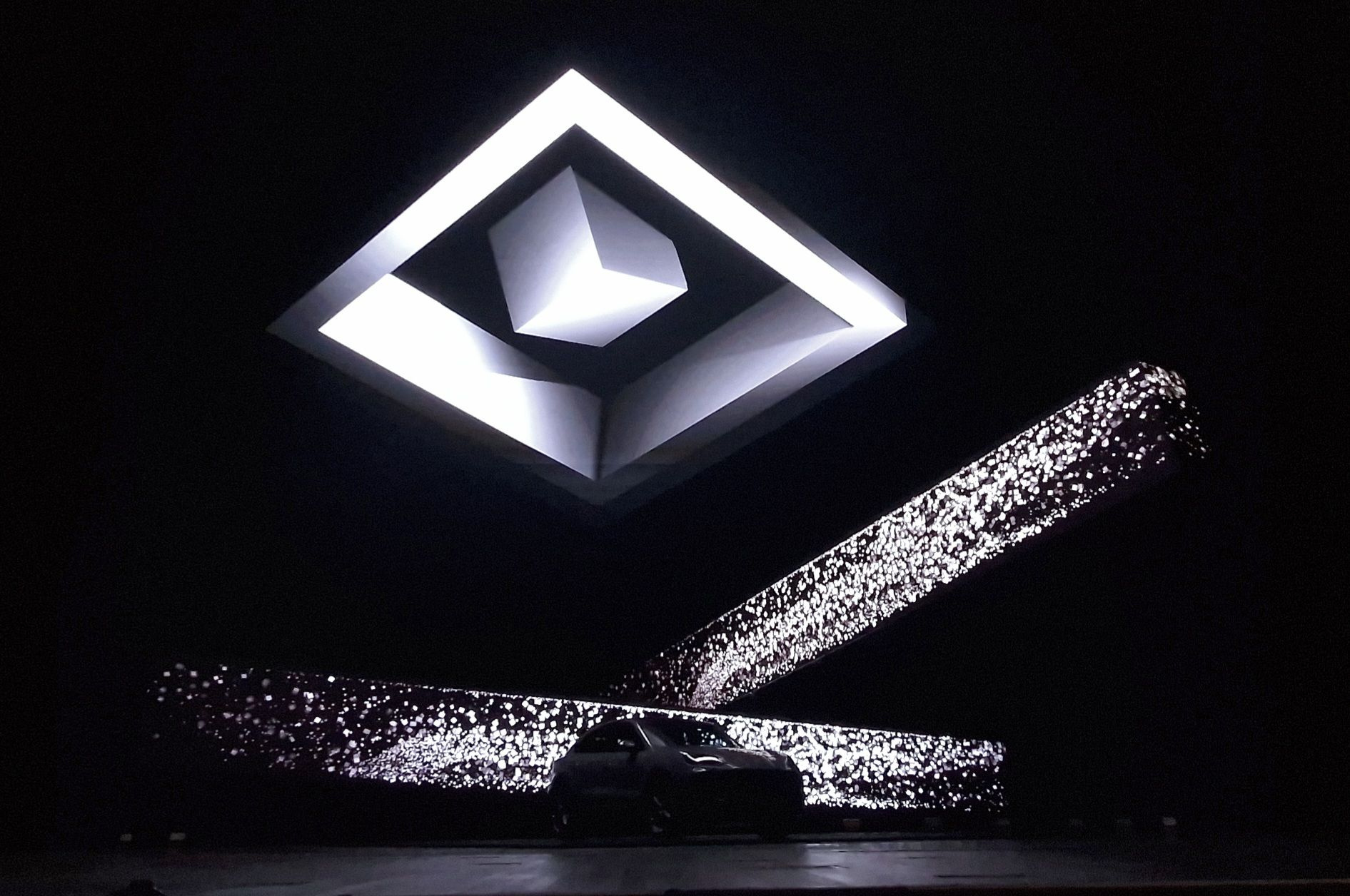 Porsche Cayenne beneath geometric illuminated forms.