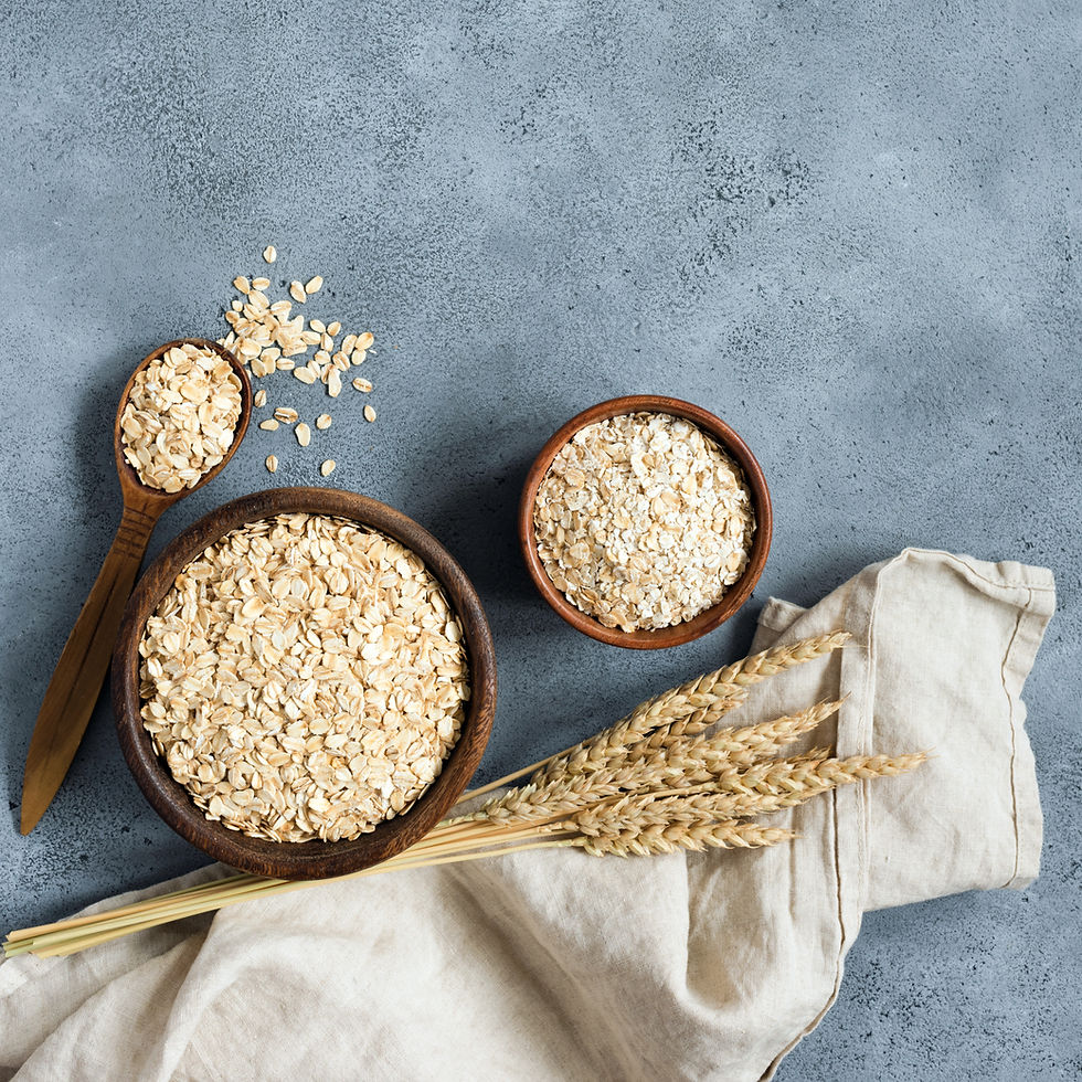 Rolled oats in wooden bowl on concrete table background, top view, copy space.jpg